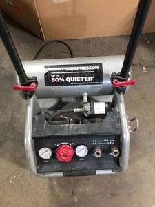 lot 118 image: Husky 4.5 Gal. Portable Electric-Powered Silent Air Compressor For Parts Customer Returns See Pictures