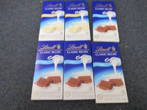 lot 221 image: 6- 4.4 oz Lindt White & Milk Chocol...