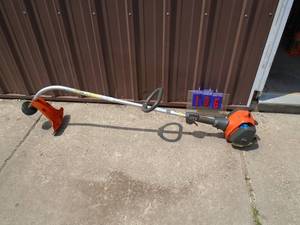 lot 106 image: Husquvarna curved shaft weed trimmer. Lightly used. Tested & works. As shown.