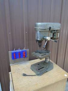 lot 115 image: Bench top drill press. 5 speed. Tested & works. Clamp has been welded. As shown.