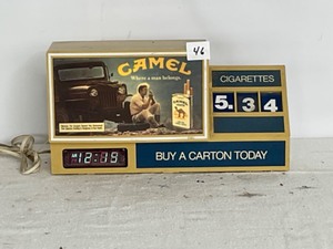 lot 46 image: Lit Table Top Cigarette Clock with Camel Advertisement price sign