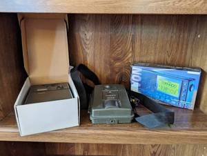 Two Trail Cameras And A Weather Radio