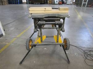 lot 19 image: Dewalt Table Saw With Stand - Missing blade guard, Fence, and other small parts - USED IN WAREHOUSE, Works Well - SOLD AS IS
