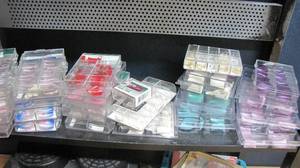 lot 85 image: Compartmentalized containers filled with nail items