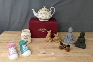 lot 165 image: Lot of 10 Decorative Items Coin Banks, Meditating Buddhas, Vintage Opera Glasses, Victorian Trading Co Roses Teapot, Wax Potpourri Warmer and More K