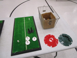 lot 202 image: Golf Driving Mat wExtra Rubber Tees, Putting Trainers, Box of Tees & Misc.