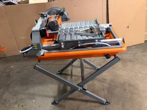 lot 14 image: RIDGID 9 Amp Corded 7 in. Wet Tile Saw with Stand Customer Returns See Picutures