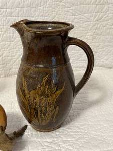 lot 101 image: Kokopelli Candlestick, Wood Clock, Pottery Pitcher and Metal Birds