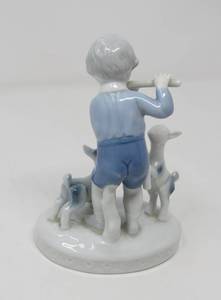 lot 32 image: Gerald Porcelain boy playing flute figurine
