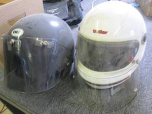 box of vintage motorcycle helmets a...