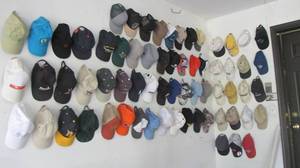 lot 120 image: Tons of hats hanging on the wall.
