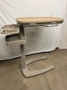 lot 10 image: MSRP $2000 TOP OF THE LINE & AWARD WINNING STRYKER TRU-FIT SPLIT TOP HEIGHT ADJUSTABLE OVERBED TABLE WSLIDE OUT VANITY COMPARTMENT & MIRROR ON BOTH SIDES PLUS SIDE TRAY WITH CUPHOLDERS - LIKE NEW