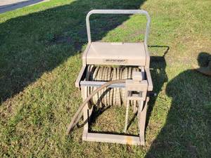 lot 262 image: Rolling Hose Reel and Hose with Assorted Valves and Nozzles