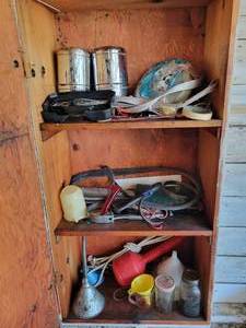 lot 293 image: Contents of Wall Cabinet - Strap Wrenches, Center Caps, Funnels and More
