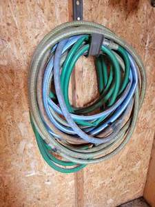 lot 497 image: Lot Against Wall - Pick Axe, Sprinkler, Hoses and More