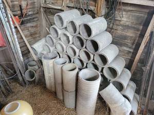 lot 32 image: Contents of Building - 40 Concrete Cylinders (12 x 6), 30 4x4 Deck Post Blocks, Lumber, Copper Ground Wire, Skeeter Eeter, Tin Sheets, Fencing and More