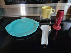 lot 134D image: Lot of Homer-Laughlin Fiestaware Turquoise Tab Handled Cake Plate, White Spoon Rest, Yellow Coffee Mug, and Cinnabar Bud Vase