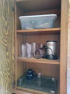 lot 140 image: Contents of Cabinet - Magic Bullet with Cups, Lids, and More