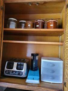 lot 141 image: Contents of Cabinet - GE 4-Slice Toaster, Vintage Cheese Crocks, and More