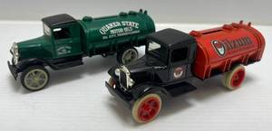 lot 56 image: Two  Ertl Collectibles Die- Cast Metal Banks (No Boxes)  With Motor Oil Advertisement 1 ( Quaker State ) Tanker Truck 1 ( Oilzum ) Tanker Truck