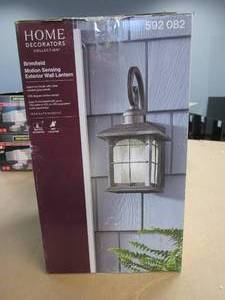 lot 134 image: Home Decorators Collection Brimfield Motion-Sensing 14.2 in. Aged Iron 1-Light Outdoor Line Voltage Wall Sconce (OPEN BOX)