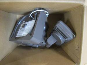 lot 161 image: Defiant 240 Degree Integrated LED Motion Sensor Bronze Two Head Outdoor Flood Light with Multi-Power Source Technology (OPEN BOX)