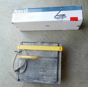 lot 16 image: Like new 12 inch vinyl tile cutter and used but working ceramic tile saw