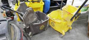 lot 89 image: 2 mop buckets, one brown one yellow