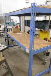 lot 95 image: Steel shelving unit with plywood shelves 24 inch deep 69 long 60 tall