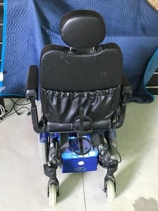 lot 5 image: Quickie  Electric wheelchair with manuel and oxygen tan holder on back