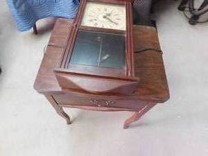 lot 191 image: Sewing machine in stand and wood clock with pendulum and key