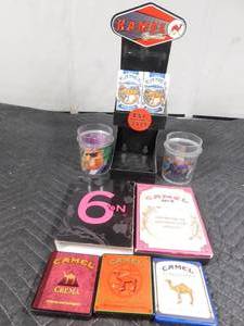 lot 208 image: Metal Kamel cigarette display, 2 empty packs of Sturgis Camel cigarettes, 2 Camel glasses, 3 Camel tins