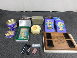lot 210 image: Camel Zippo display plaque, tins, matches, ashtray, lighters, rolling papers and metal altoid strips case