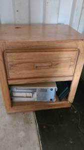Small wooden side table with contents