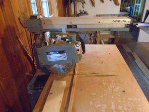 lot 103 image: Delta radial arm saw. Nice used condition. Right out of the shop. As shown.