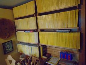 lot 115 image: Wall of national geographic magazines. From 1958 approx 50 years worth. Must take all. As shown.