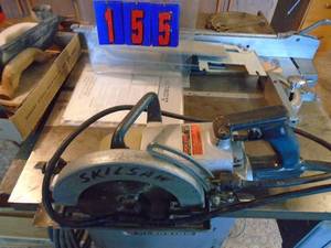 lot 155 image: Worm drive skil saw in metal case with lots of extra blades. As shown.