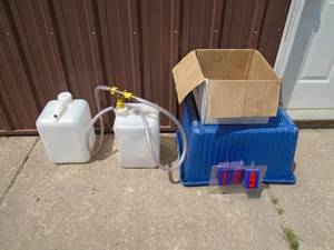 Qty of 2 plastic jugs with tubing & motor ear muffs. As shown.