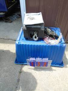 12 volt electric winch with mount plate, cables & controls. Was working but appears to be bound up As shown.