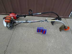 Qty of 2 gas weed trimmers. Homelite appears lightly used. As shown.