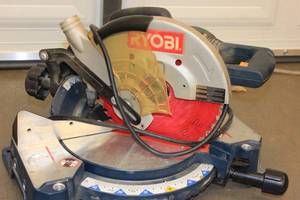 lot 10 image: Ryobi 15 Amp 10 in. Corded Sliding Compound Miter Saw with LED Cutline Indicator (TS1352)