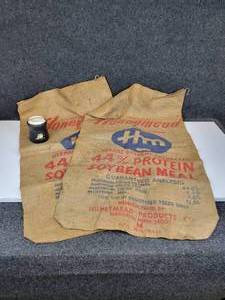 lot 692 image: Pair of 100# Honeymead Burlap Bags and Can Koozie