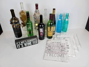 lot 712 image: Lot of Wine-Themed Home Dcor - Bottles, Shelf Sitter, Bottle Jewelry, and Dish Towels