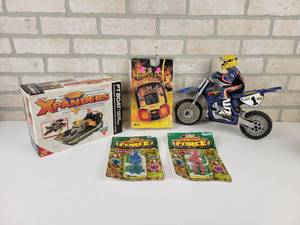 lot 604 image: Vintage galoob Xpanders Transforming Boat in original Box, (2) Battle Force Paratroopers, Hercules Hand Held Game and TYCO RC Dirt bike (No Remote, Untested)