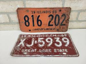 lot 658 image: 1969 Illinois Land of Lincoln License Plate and 1969 Michigan Great Lake State License Plate