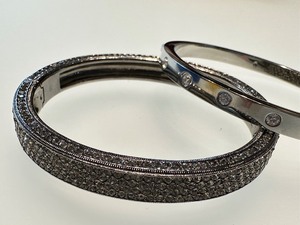 lot 84 image: Two Bangle Bracelets including a Kate Spade Bracelet