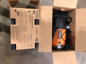 lot 19 image: RIDGID 6 Qt. NXT Backpack Vacuum Cleaner with Filters and Locking Accessories for Dry Applications    Customer Returns See Pictures