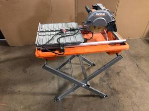 lot 31 image: RIDGID 9 Amp Corded 7 in. Wet Tile Saw with Stand  Customer Returns See Pictures