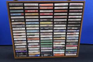 100 CASSETS IN NICE WOOD DISPLAY BOX.