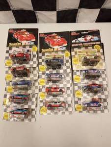 lot 73 image: Racing Champions 164 Scale Die Cast Cars With Collectors Card and Display Stand